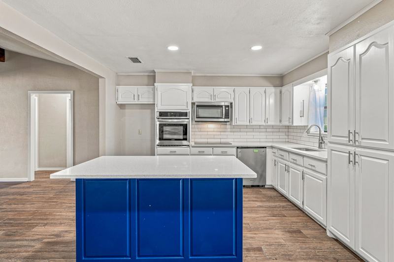 Kitchen island and cabinetry looking toward the hallway