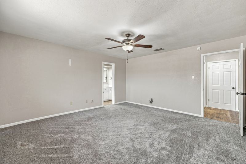Carpeted bedroom with ceiling fan, second view