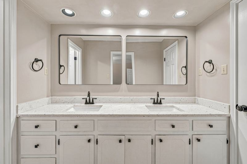 Bathroom with a double vanity and two mirrors