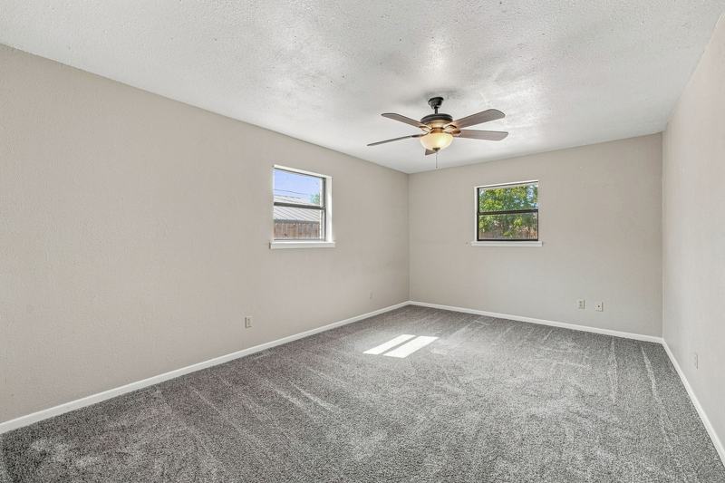Carpeted bedroom with two windows