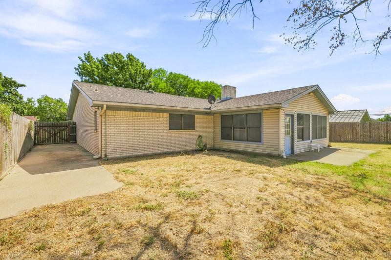 Back of the home and fenced yard