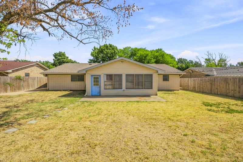 Back of the home seen from across the yard