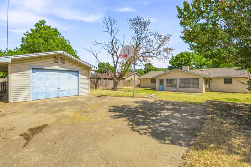 Detached shop and concrete drive in the backyard