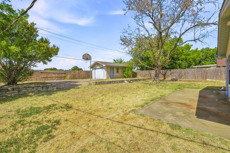 Backyard looking toward the shop along the wood fence